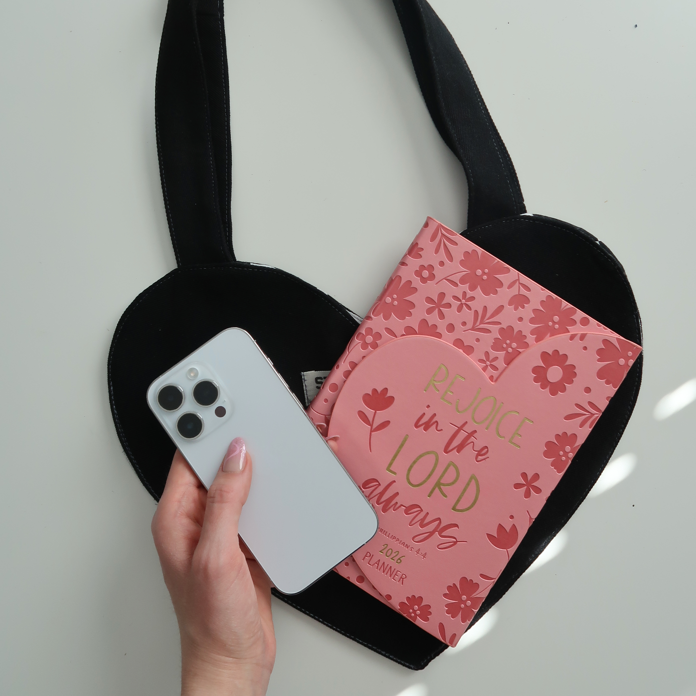 black heart tote bag with note book and cellphone