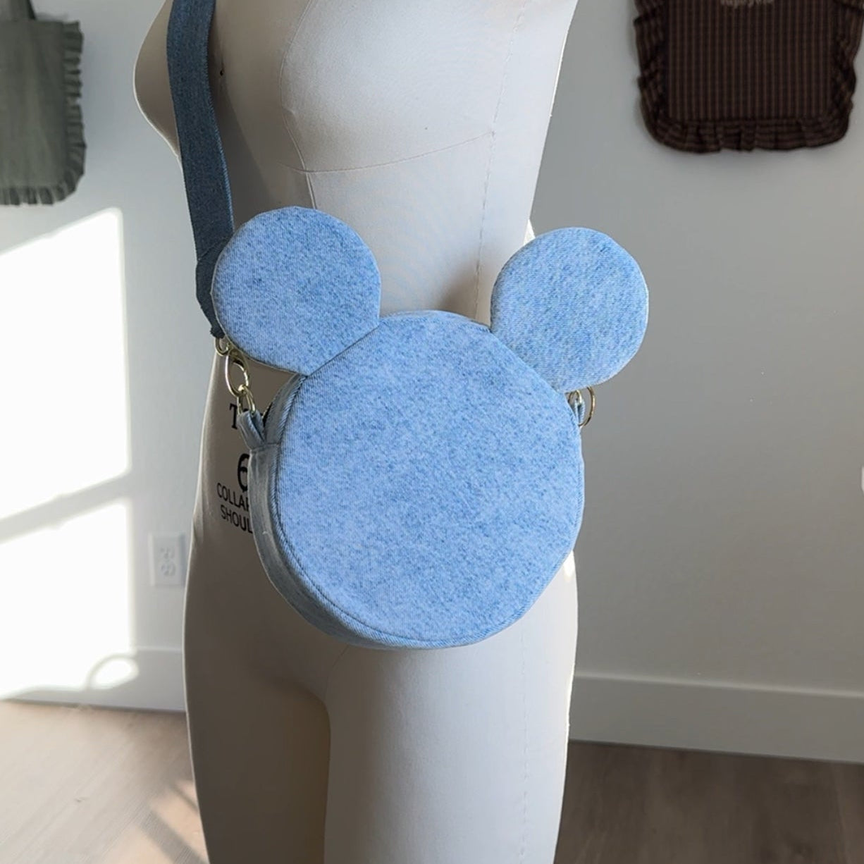 Blue round bag with ears on a mannequin against a neutral background sewing pattern diy upcycling