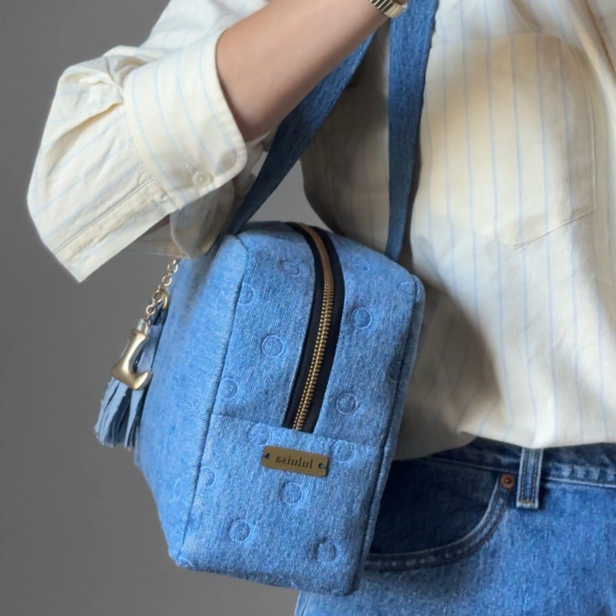 denim shoulder bag on a women wearing yellow shirt